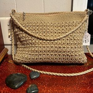NWOT The Sak crocheted natural neutral color bag. Perfect new condition. No flaw